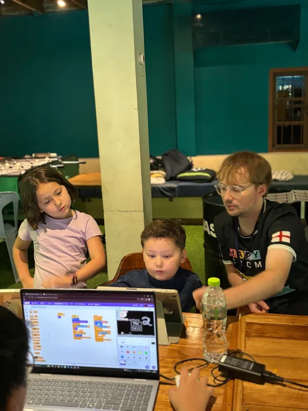 Young student intensely focused on debugging their Scratch project
